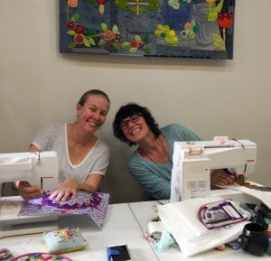Skye and Charlotte happily sewing