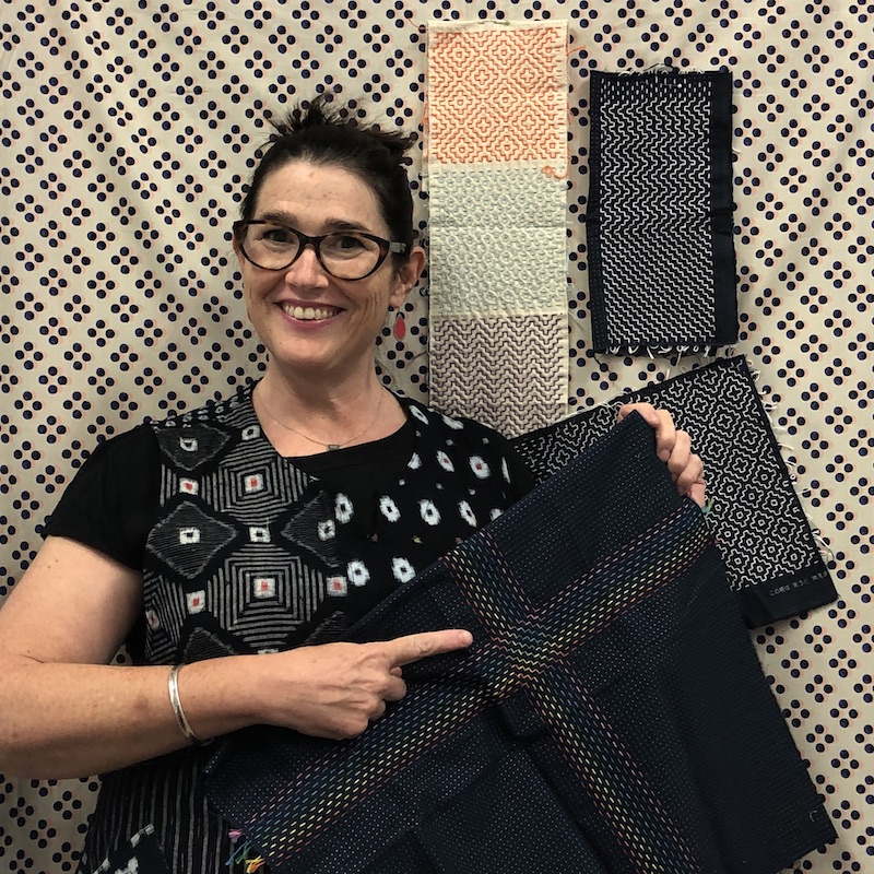 Sharon with examples of Hitomezashi Stitching